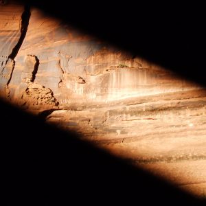 shaft of sunlight on red cliff wall at Canyon de Chelly symbolizes observing in an expanded state of now awareness using mindfulness practices.