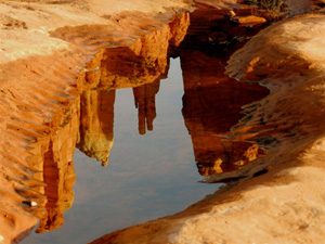 Sedona red cliff landscapes reflected in water is symbolic of Sedona as a powerful place for vision quest