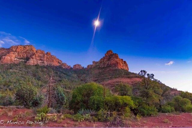 Full moon rising in sunset sky over Sedona red cliff. This symbolizes solo circle vision quest ceremony, full moon & stars inspiration and ceremony circles