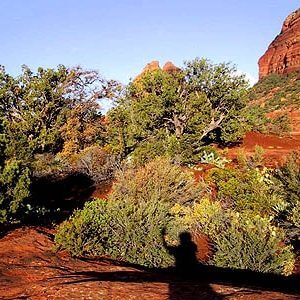 Shadow of a solo person in red cliffs of Sedona, Arizona practicing mystic vision skills in nature.