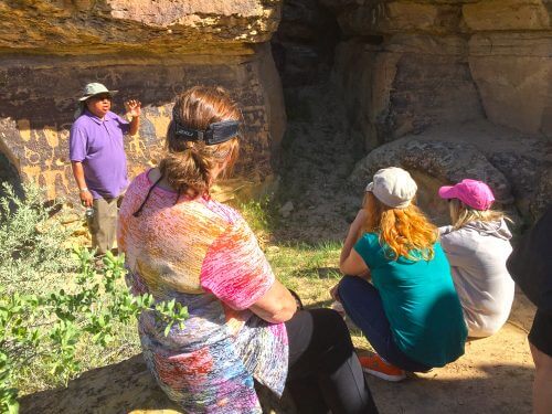Hopi guide describing Puebloan Ancestor rock art meanings to our visitor group during a Hopi Spirit Journey.